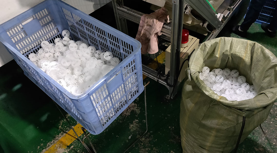 Plastic ripple ring packing being dumped into cooling tower fill section showing even distribution